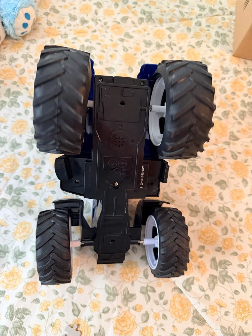 Medium plastic blue and black electronic toy tractor, lights up with sound